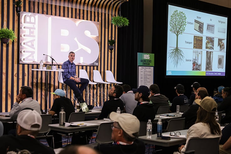 Man on stage presenting to audience